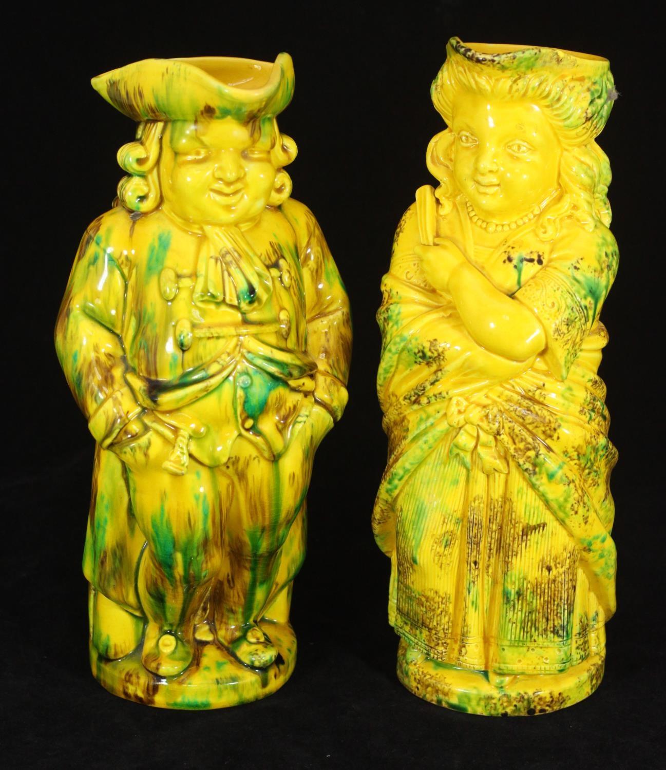 A pair of Mintons Toby jugs 'Barrister' and 'Lady with a Fan', in yellow, green and brown