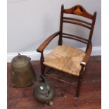 A child's oak armchair with rush seat, the top rail inlaid with a scene of a cow jumping over the