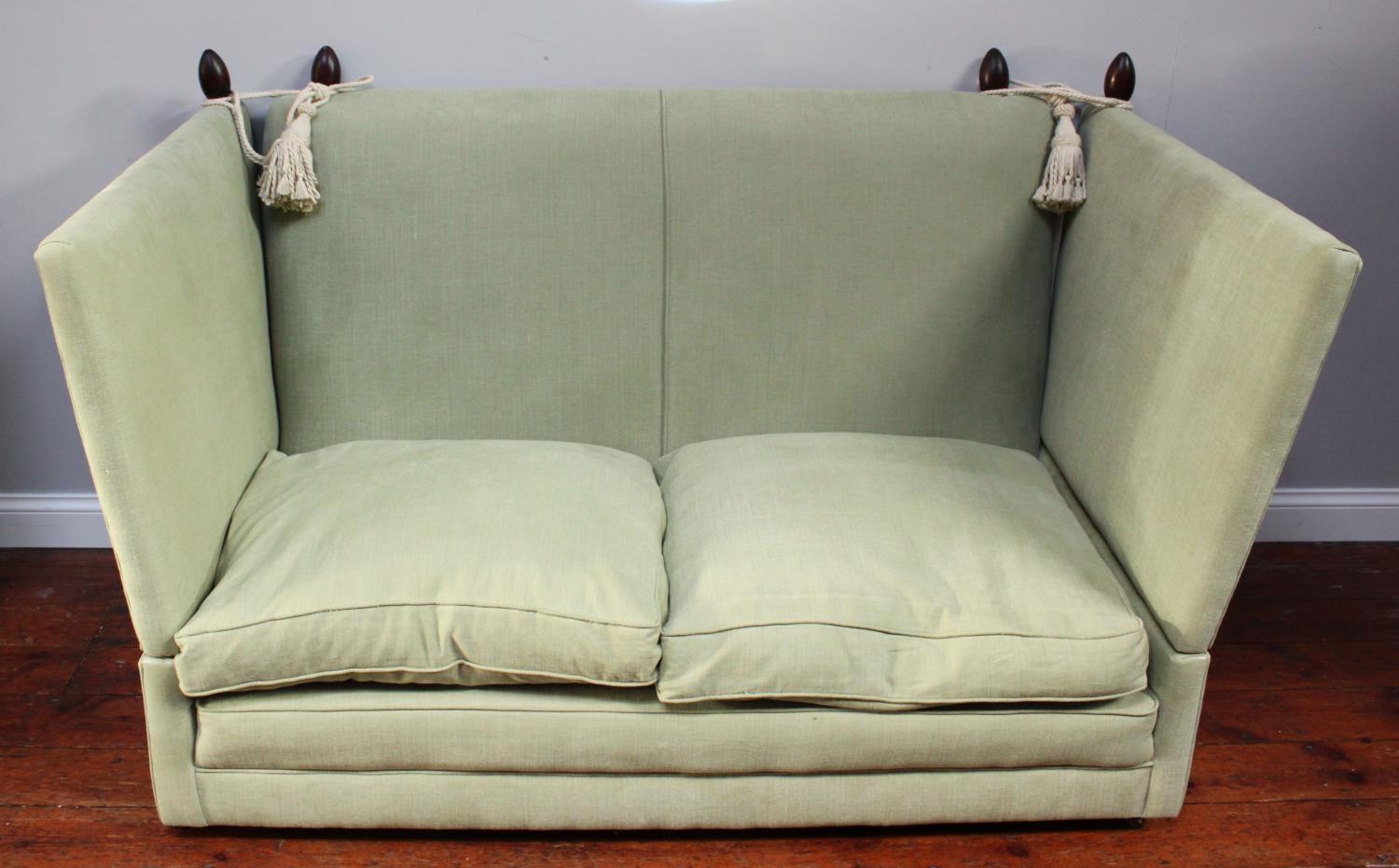 A Knole style drop end sofa, of typical form, with rope tied and tassel hung drop ends, pointed