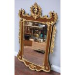 A late 19th century mahogany and parcel gilt wall mirror in the George II style, of rectangular form