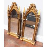 A pair of late 19th / early 20th century mirrors in the gothic style with arched tops and barley-