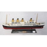 A painted wooden model of the Titanic, approx. 50cm long