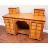 An oak pedestal desk with two miniature cupboards atop either side, the pedestals with four