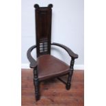 A stained oak armchair in the manner of Leonard Wyburd for Liberty & Co, with tall narrow reeded