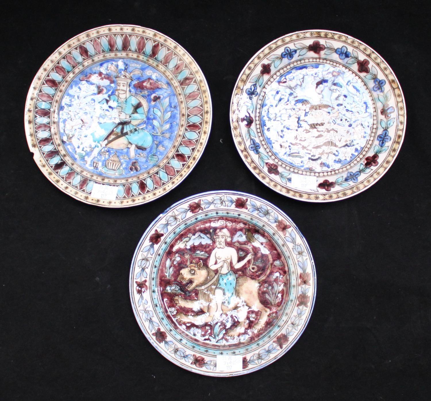 Three 19th century Persian/Ottoman pottery wall plates, each tin-glazed and decorated in blue, mauve