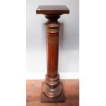 An early 20th century stained walnut torchere stand with square top on gilt-metal mounted fluted