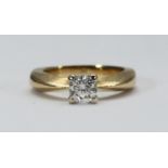 An 18ct gold solitaire diamond ring, four-claw set with a round brilliant cut diamond. The diamond