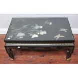 A Chinese lacquer rectangular coffee table with glass top over carved and applied coloured hardstone