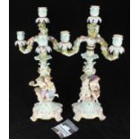 A pair of Meissen porcelain figural five-light candelabra in the Rococo style and emblematic of