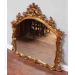 A large over-mantel mirror in ornately carved, foliate gilt frame, 120cm wide