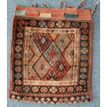 A hand-knotted Caucasian saddle bag, decorated with blue and red guls to a geometric multi-border,