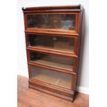 A four-section stained walnut Globe Wernicke bookcase with typical glazed up-and-over doors, 87cm