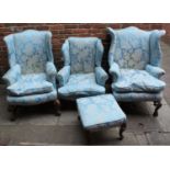 Three various Victorian wing-backed armchairs and a pouffe, all upholstered in blue damask fabric