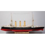 A scratch built scale model of H.M.S Kent, with planked hull and hand-painted detailing, raised on