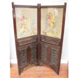 A Victorian bi-fold heavily carved and painted dressing screen / room divider, the top panels with