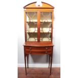 An Edwardian mahogany and satinwood cross-banded two-door display cabinet in the Sheraton style,