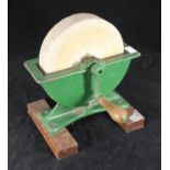 A tabletop cast iron hand operated knife sharpener or grinder, on a wooden base, 25cm long