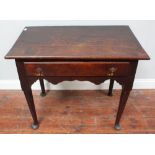 Mid-18th century oak side table with single drawer and shaped apron on turned and tapering