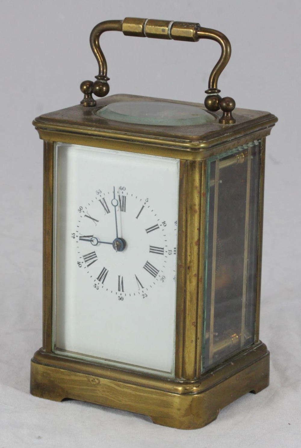 An early 20th century French brass carriage clock, with white enamel dial, 14cm high