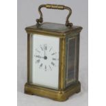An early 20th century French brass carriage clock, with white enamel dial, 14cm high