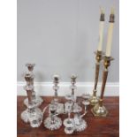 Two pairs of silver plated candlesticks with detachable pans and loaded bases, together with a