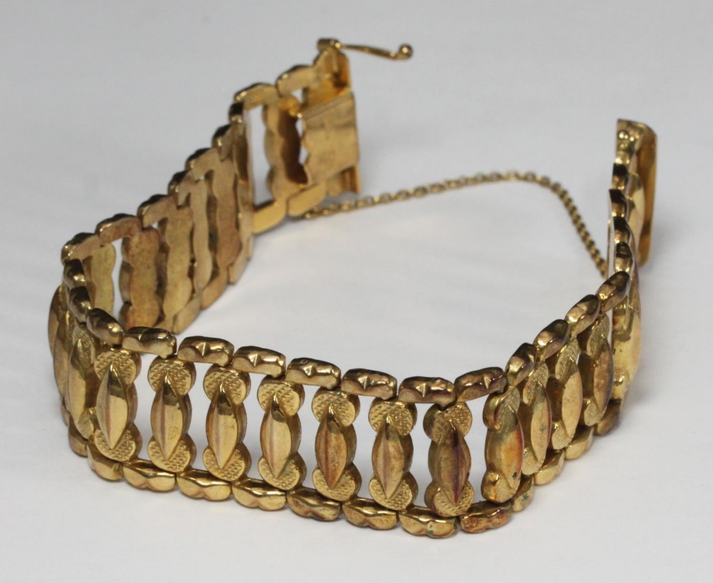 A 14ct gold bracelet, articulated links, with safety chain, stamped '585,' 30.1g