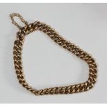 A 9ct gold curb-link bracelet, with sliding-clip catch and safety chain, 9.9g