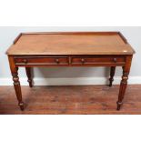 A Victorian mahogany two-drawer side table/ desk with half-galleried top, two freeze drawers, with