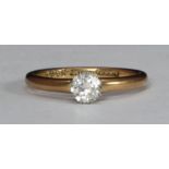 An 18ct gold and solitaire diamond ring, eight-claw set with a round faceted diamond, estimated at