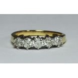 An 18ct gold five-stone diamond ring, claw-set five round brilliant-cut diamonds, each estimated 0.