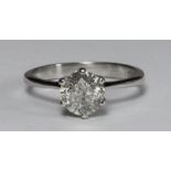 An 18 carat white gold solitaire diamond ring six claw set with a round brilliant cut diamond. The