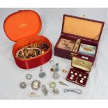 A quantity of costume jewellery including necklaces and brooches, together with a cased set of MOP