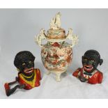 Two assorted cast iron 'Negro' moneyboxes, together with a Japanese Satsuma jar and cover, with lion