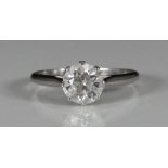 A platinum and diamond solitaire ring, claw set, a round 'transitional' cut diamond weighing