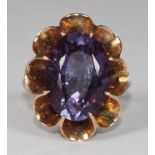 An unmarked yellow gold dress ring, eight claw-set with a large oval faceted Alexandrite,