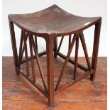 A mahogany 'Thebes' stool designed for Liberty & Co, with label to underside,For an identical stool,