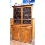 18th century mahogany bookcase, with swan-neck and fret pierced carved pediment, astragal glazed