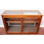 A mahogany haberdashery/shop display counter, the glass top and glazed front enclosing two-section