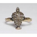 A Victorian gold and diamond ring, the top cast as a vase and cover set with Old Mine Cut