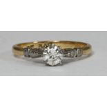 An 18ct gold and platinum set solitaire diamond ring, the RBC diamond spreading approximately 0.35