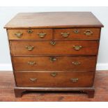 An early 18th century 'dated' oak chest of two short and three long drawers, the top inlaid with