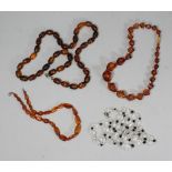 An amber necklace formed from 27 graduated, shaped beads, together with a smaller amber necklace,