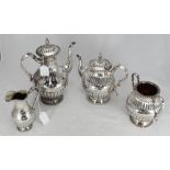 A four-piece silver-plated tea and coffee service, each piece decorated with a reeded and fluted