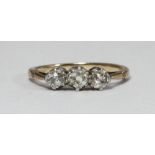 An 18ct gold three-stone diamond ring, claw-set three Victorian cushion-cut diamonds, estimated 0.60