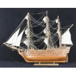 A fully-rigged wooden model of a three-decked ship of the line, modelled preparing to set sail,