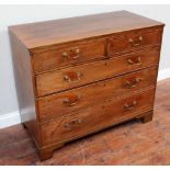 A George III mahogany chest of two short and three long graduated drawers with boxwood string,