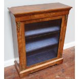 A Victorian walnut single-door pier cabinet, with gilt-metal mounts and boxwood arabesque