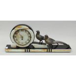 An Art Deco black slate and marble mantel clock modelled with two spelter figures of birds, 61cm