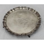 A silver salver with shaped border, raised on four pad feet, engraved 'To Margaret' etc. Chester,