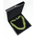 A multi-strand peridot and silver necklace approx. 18", with original label, certificate of